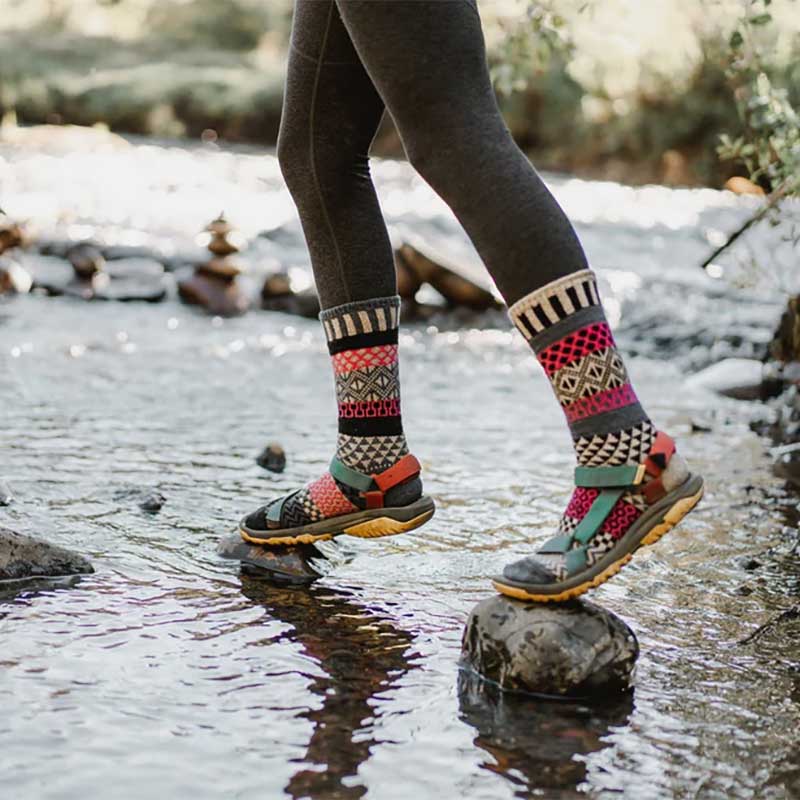 Person wearing Solmate Adults Wool Socks - Dogwood with sandals.