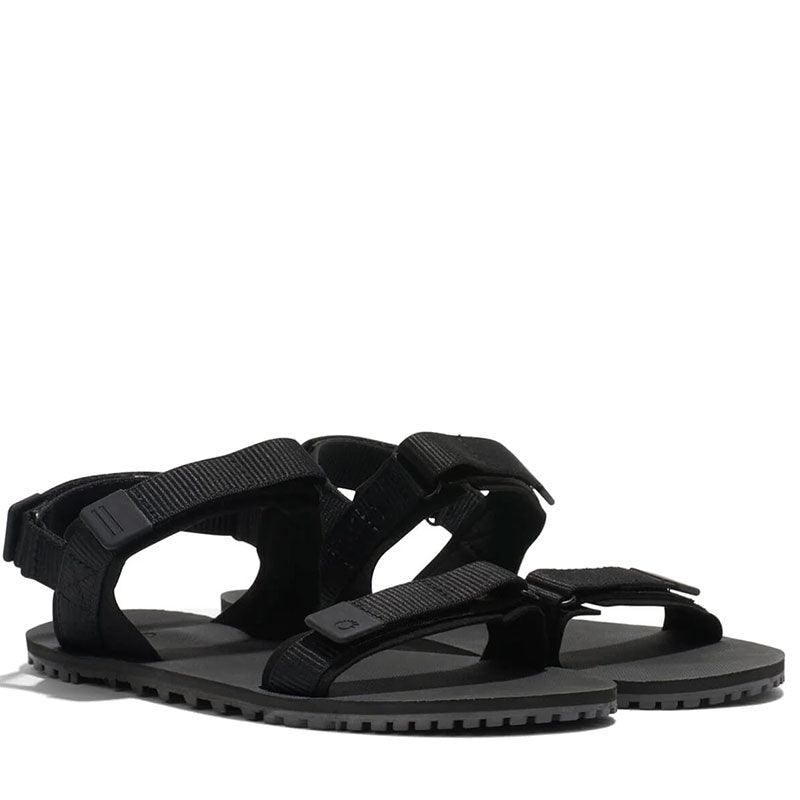 Pair of Xero Women's Sandals D-Trail - Black, angled view showing outer side and front.
