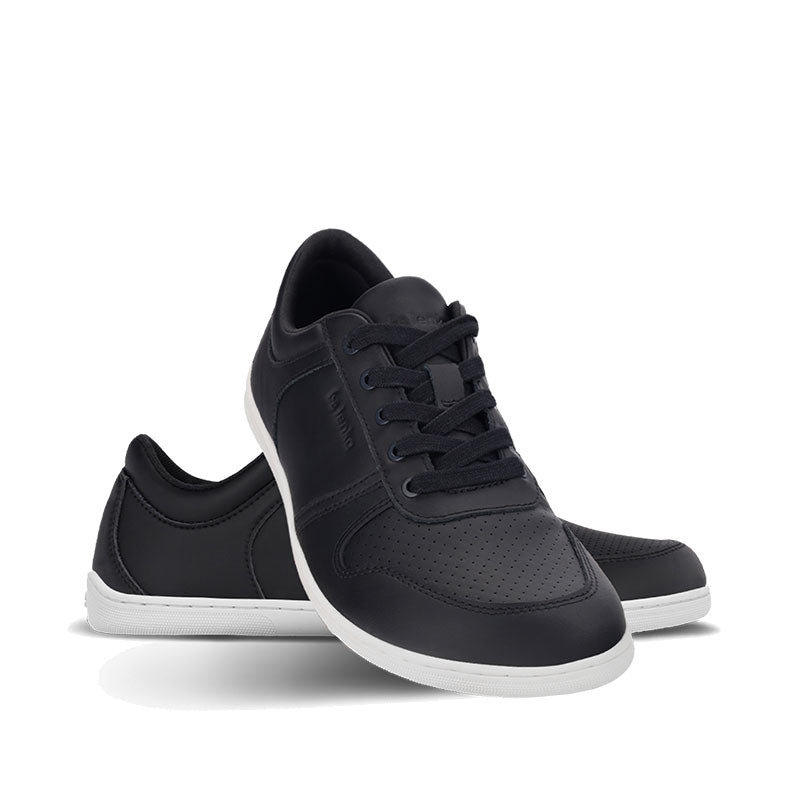 Pair of Be Lenka Adults Trainers Echo - Black and White, one angled and leaning showing the outer side, the other partially showing the inner side