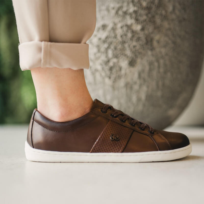 Person wearing Be Lenka Adults Trainers Elite - Dark Brown with cream trousers
