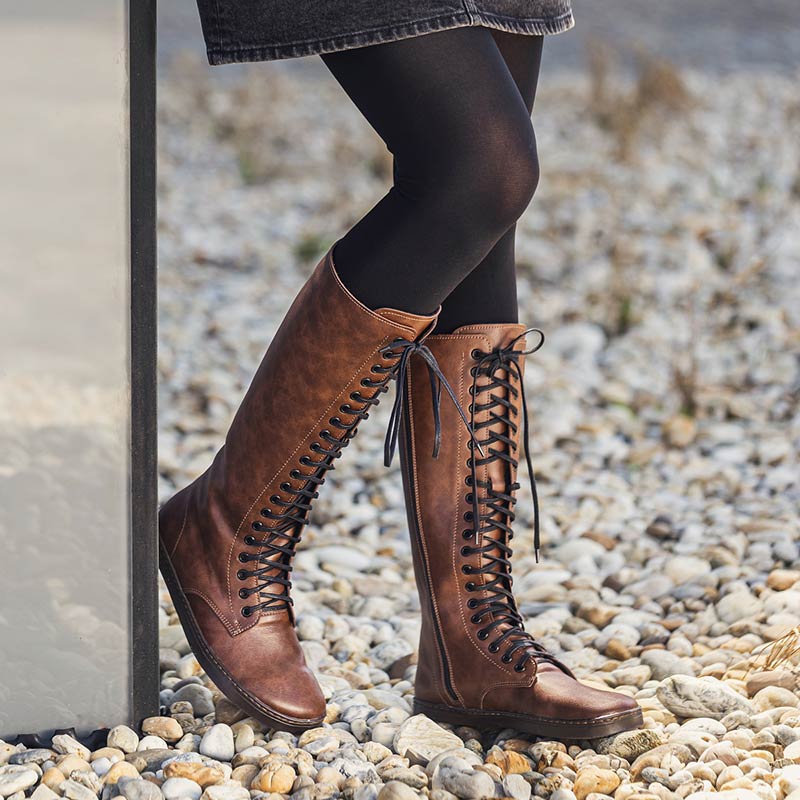 Person wearing Peerko Women's Vegan Boots Empire - Nut with black tights.