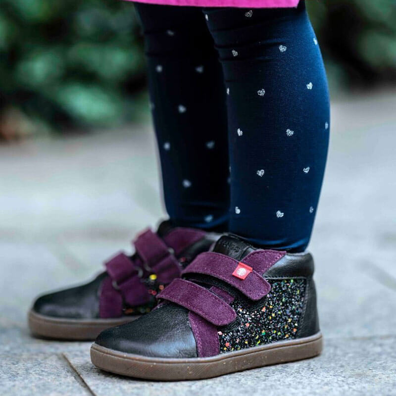 Child wearing Tikki Lang.S Kids Boots Firefly - Purple with navy patterned tights.