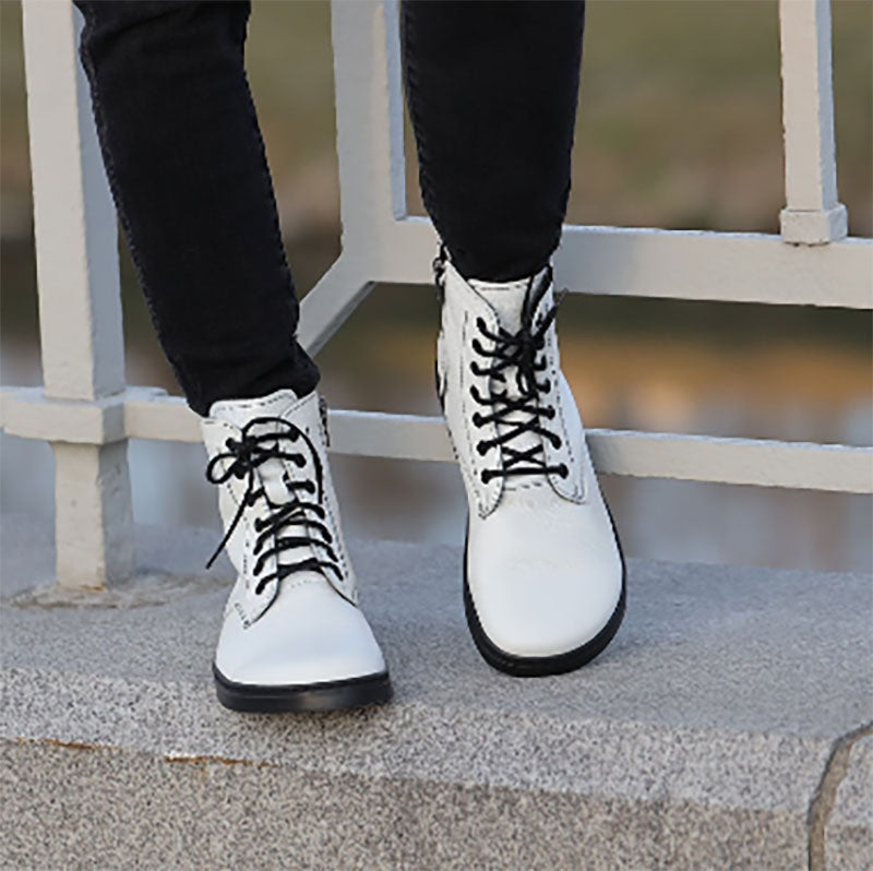 Person wearing Peerko Adults Boots Go - White with black trousers.