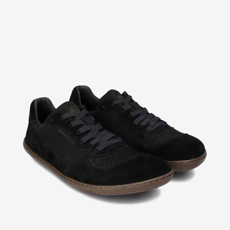 Pair of Groundies Adults Nova GO1+ Trainers in black, angled view showing outer side and front.