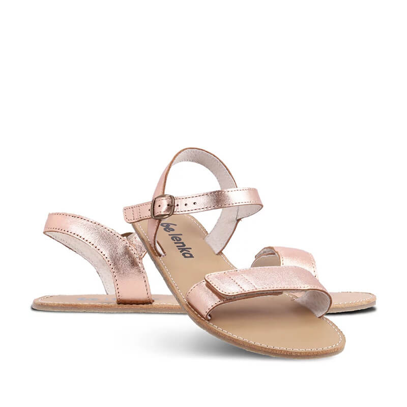 Pair of Be Lenka Women's Sandals Grace - Rose Gold, one angled and leaning showing the outer side, the other partially showing the inner side