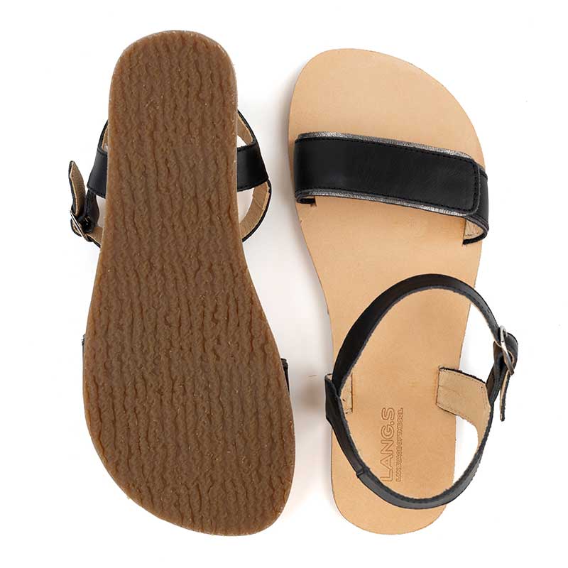 Pair of Tikki Women's Sandals Hera - Black, one showing the sole and the other showing the top view.