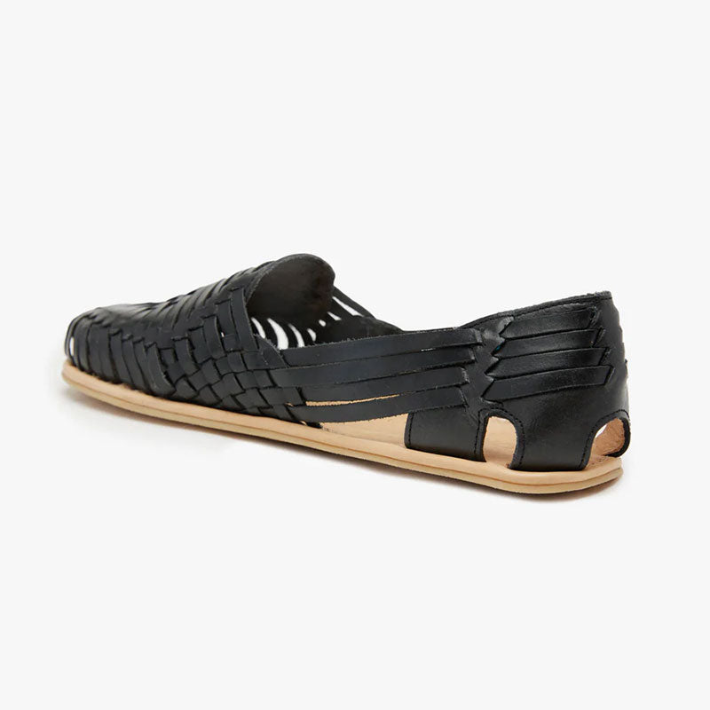 Origo Women's Huarache Slip-On Wide Sandal By Anya in black, angled view showing inner side and rear.