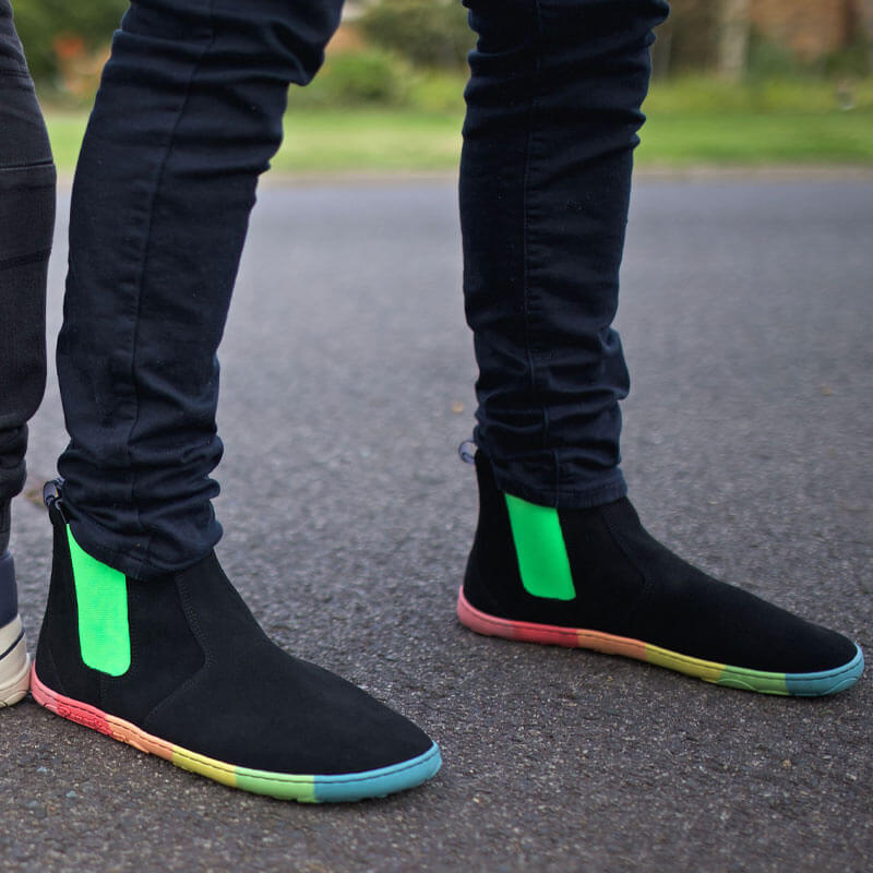 Person wearing PaperKrane Adults Skittle Neon Chelsea Boots in black with black trousers.