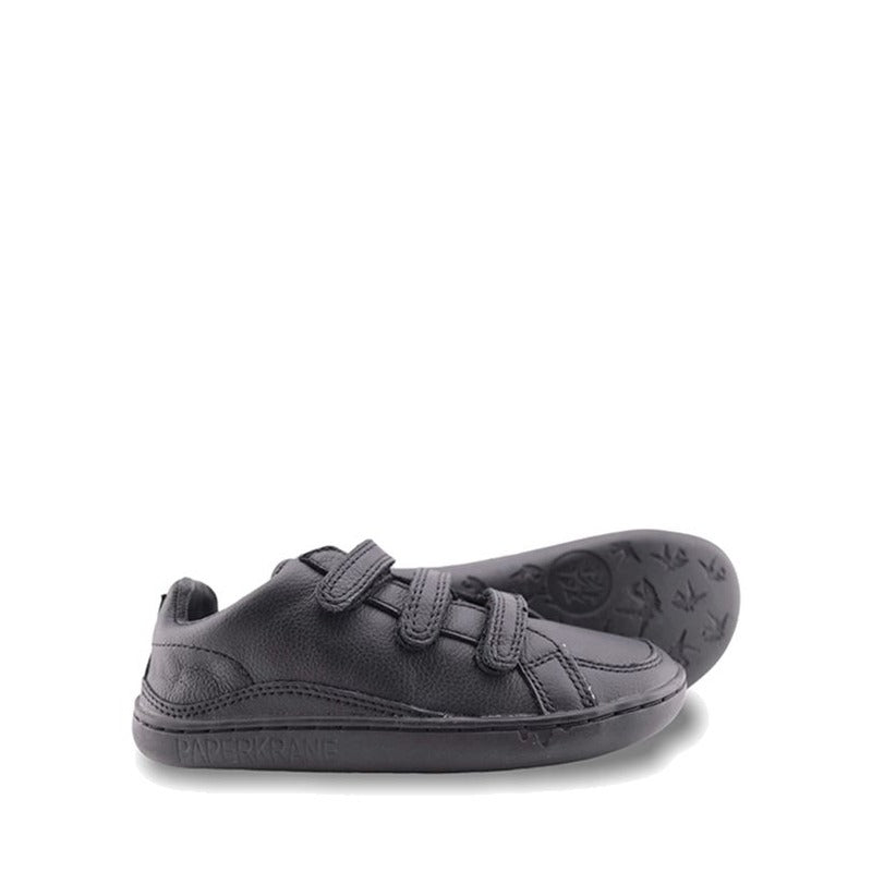 Pair of PaperKrane Kids Ruler Shoes in black, one showing outer side and the other on it's side showing a little of the sole.