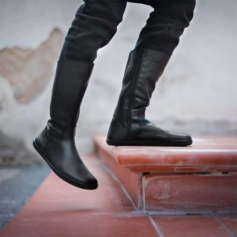 Person wearing Angles Women's Leather Boots Maira - Black with black jeans