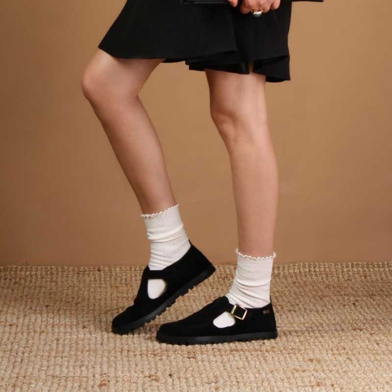 Person wearing Tikki Lang.S Women's Shoes Mira - Black with white socks.