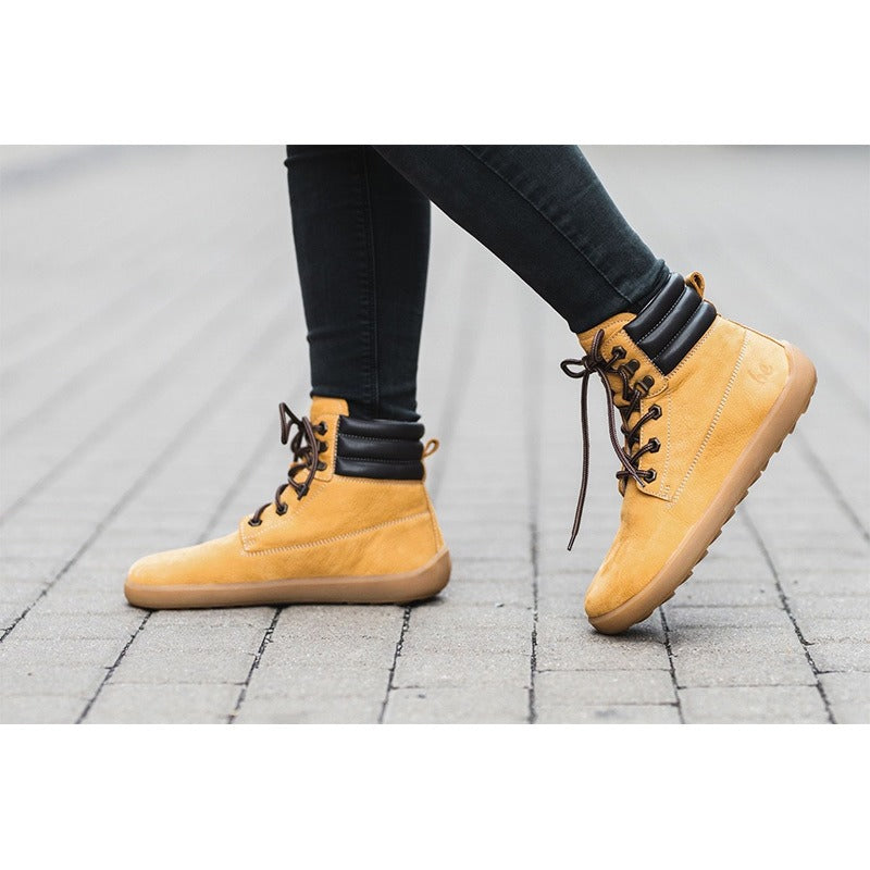 Person walking, wearin a pair of Be Lenka Adults Boots Nevada Neo - Mustard