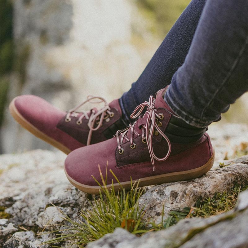 Person wearing Be Lenka Adults Boots Nevada Neo - Burgundy with denim jeans