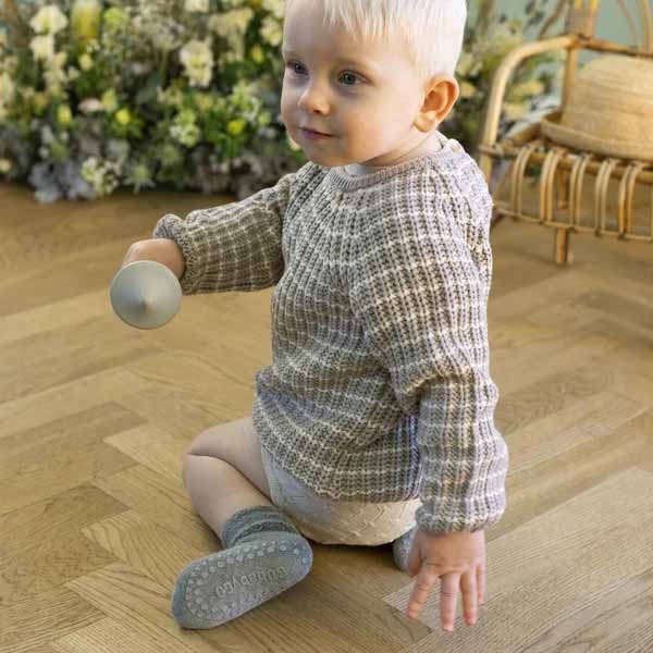 Child wearing Go Baby Go Non-Slip in grey.