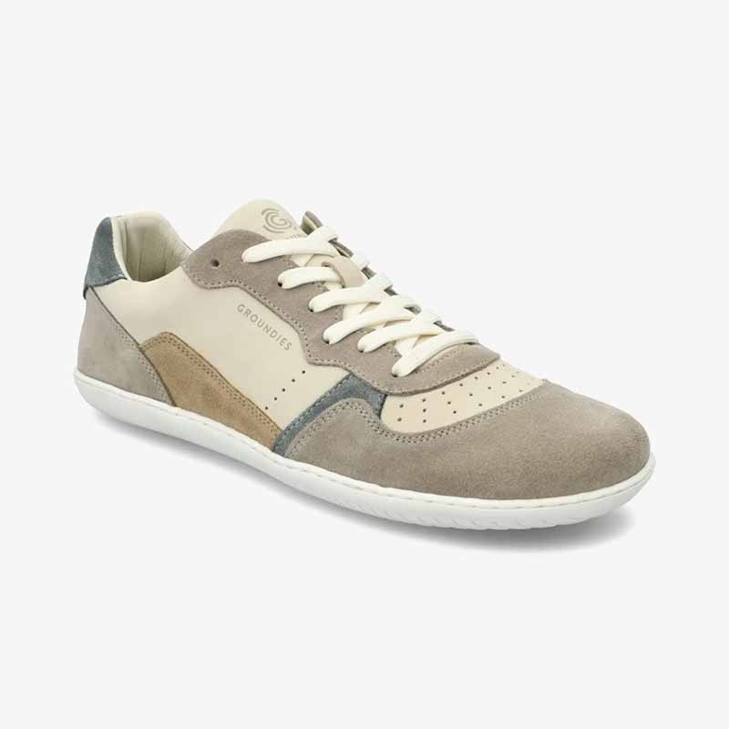 Groundies Adults Nova GO1 Trainer in beige and green, angled view showing outer side and front.