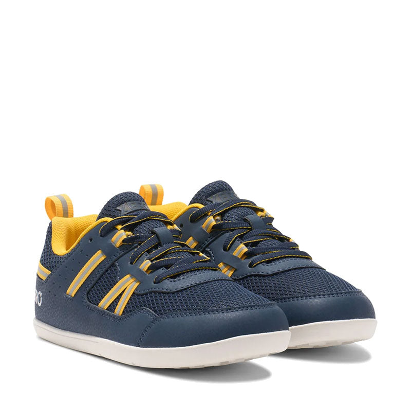 Pair of Xero Kids Trainers Prio - Dress Blue, angled view showing outer side and front.