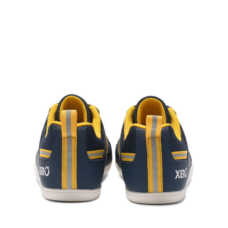Pair of Xero Kids Trainers Prio - Dress Blue, rear view.