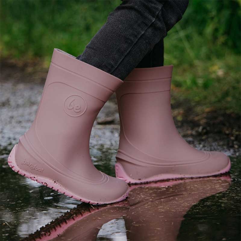 Person wearing Be Lenka Kids Wellies Pudds - Misty Pink with black jeans, side view