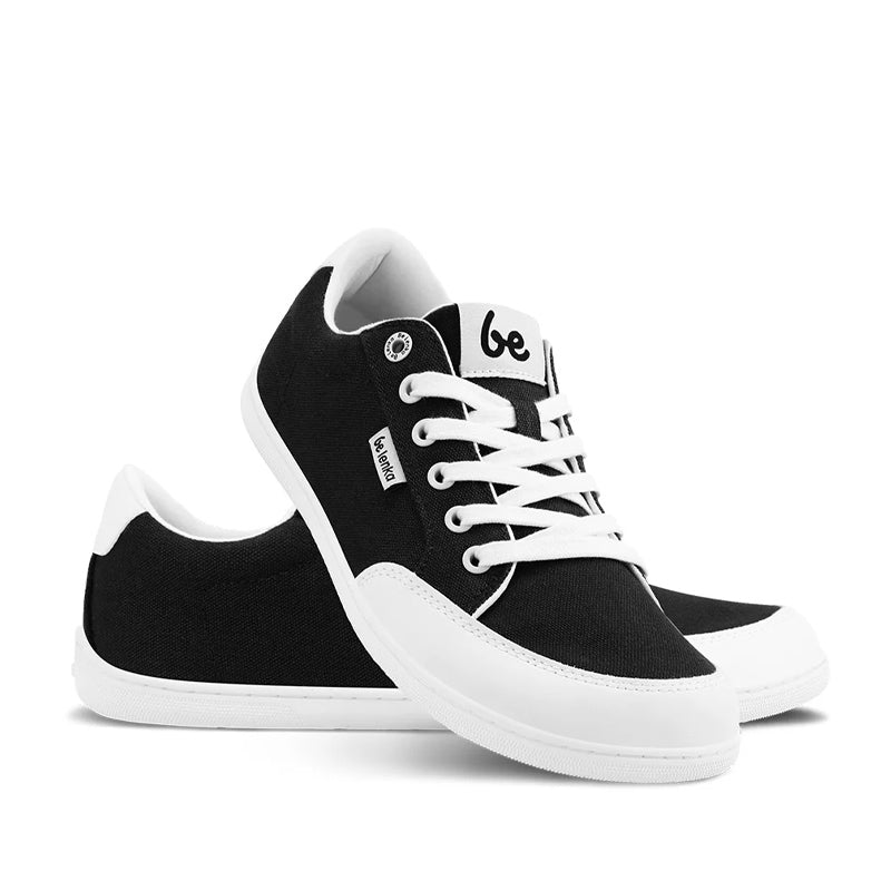 Pair of Be Lenka Adults Trainers Rebound - Black and White, one angled and leaning showing the outer side, the other partially showing the inner side