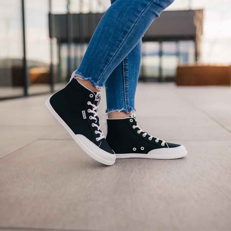 Person wearing Be Lenka Adults High Top Trainers Rebound - Black and White with denim jeans