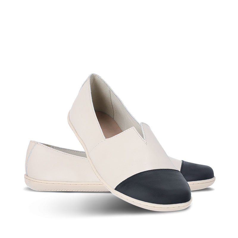 Pair of Be Lenka Women's Moccasins Rosaluna - Beige and Black, one angled and leaning showing the outer side, the other partially showing the inner side