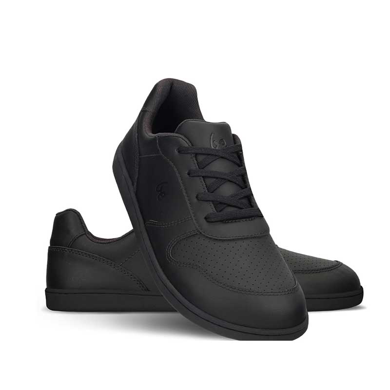 Pair of Be Lenka Junior Trainers Scoot - Black, one angled and leaning showing the outer side, the other partially showing the inner side