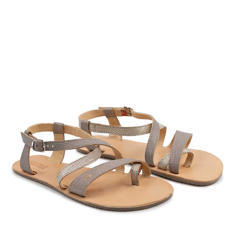 Pair of Tikki Women's Sandals Selene - Stone, angled view showing outer side and front.