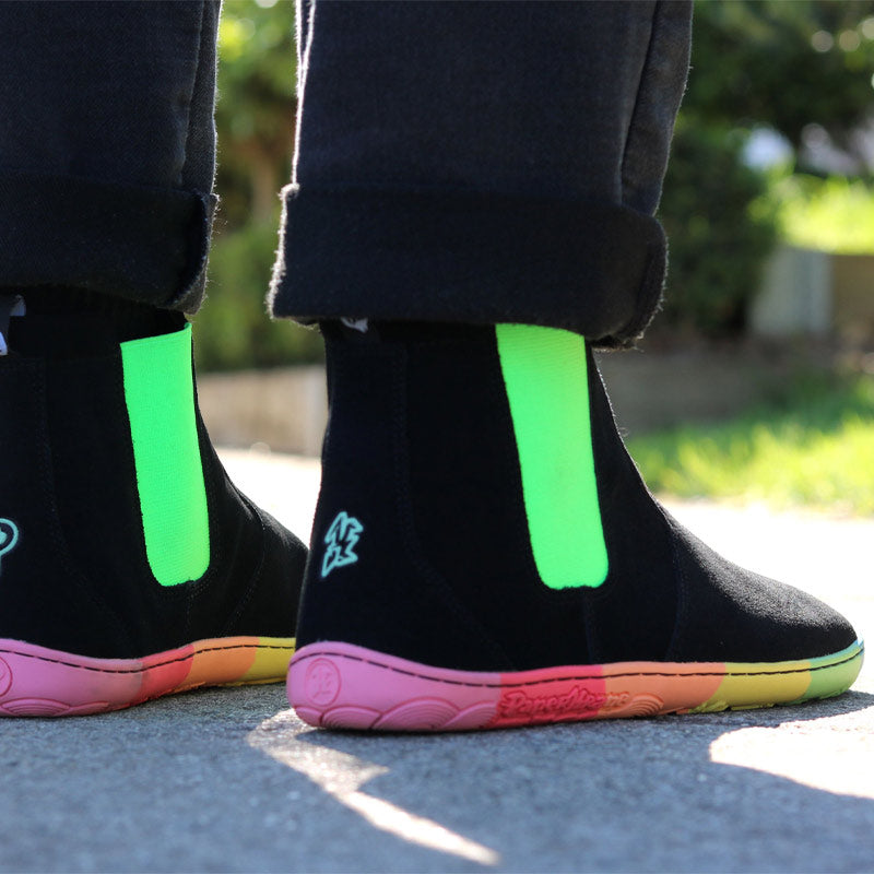 Person wearing the PaperKrane Adults Skittle Neon Chelsea Boots in black.