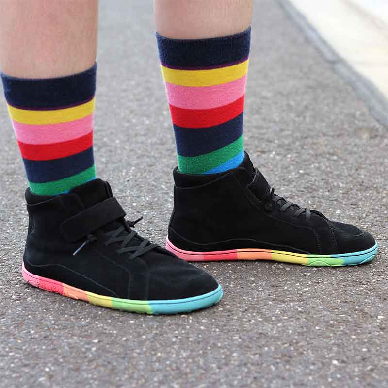 Person wearing PaperKrane Adults Skittle Mid Boots in black with stripey socks.