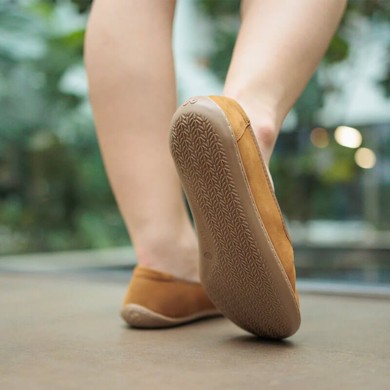 Person wearing Be Lenka Women's Ballet Shoes Sophie - Toffee Brown, sole and rear view