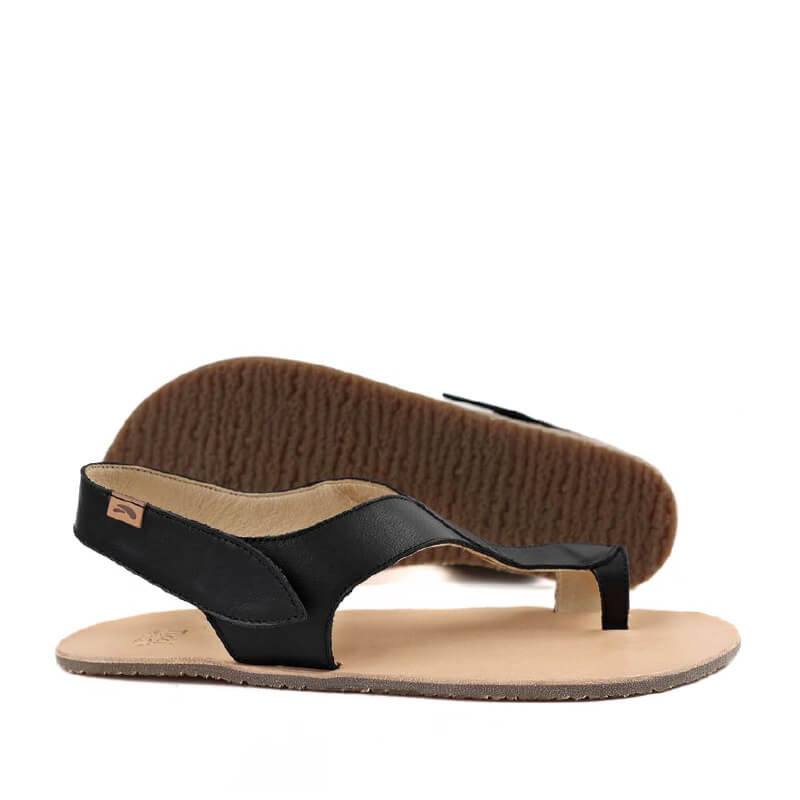 Pair of Tikki Women's Leather Sandals Soul - Black Sand, one showing the outer side and the other showing the sole view.