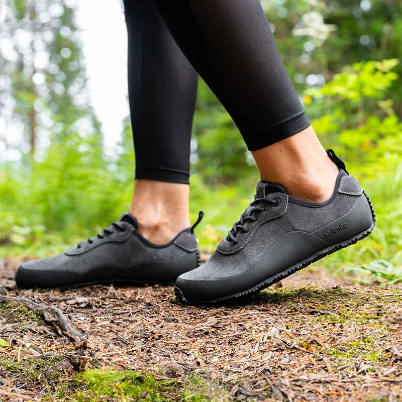 Person wearing Be Lenka Adults Shoes Trailwalker 3.0 - Dark Grey with black leggings