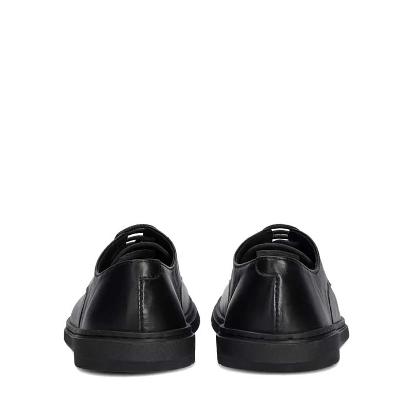 Pair of Groundies Adults Trento Shoes in black, rear view.