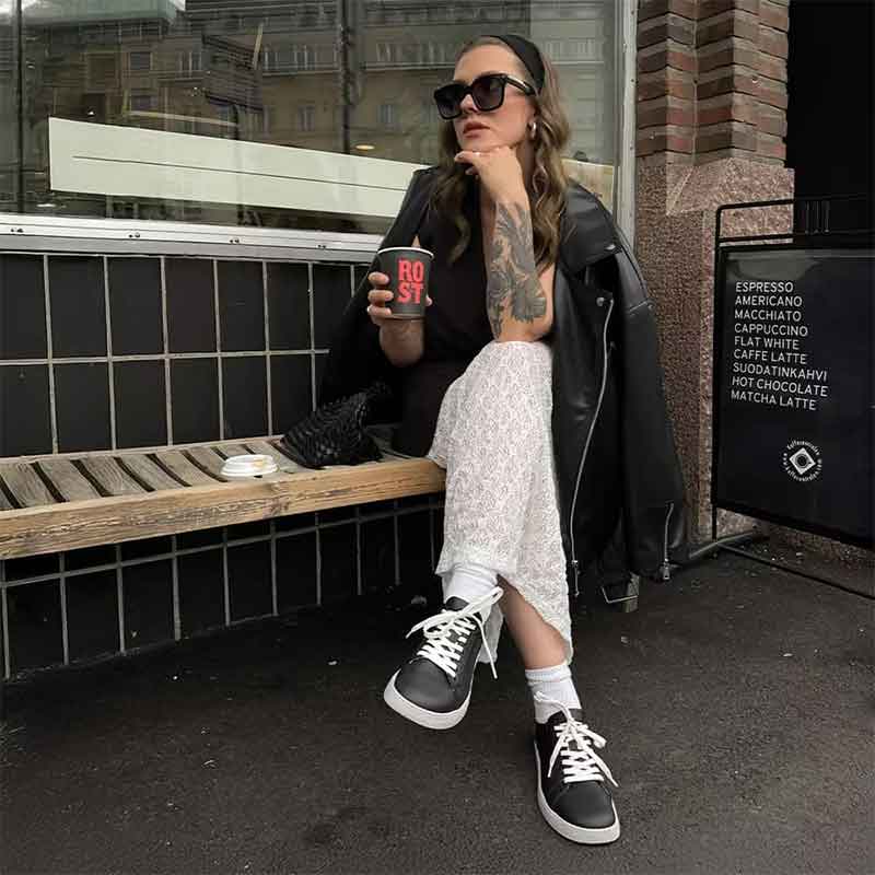Person wearing Groundies Adults Universe Trainers in black and white.