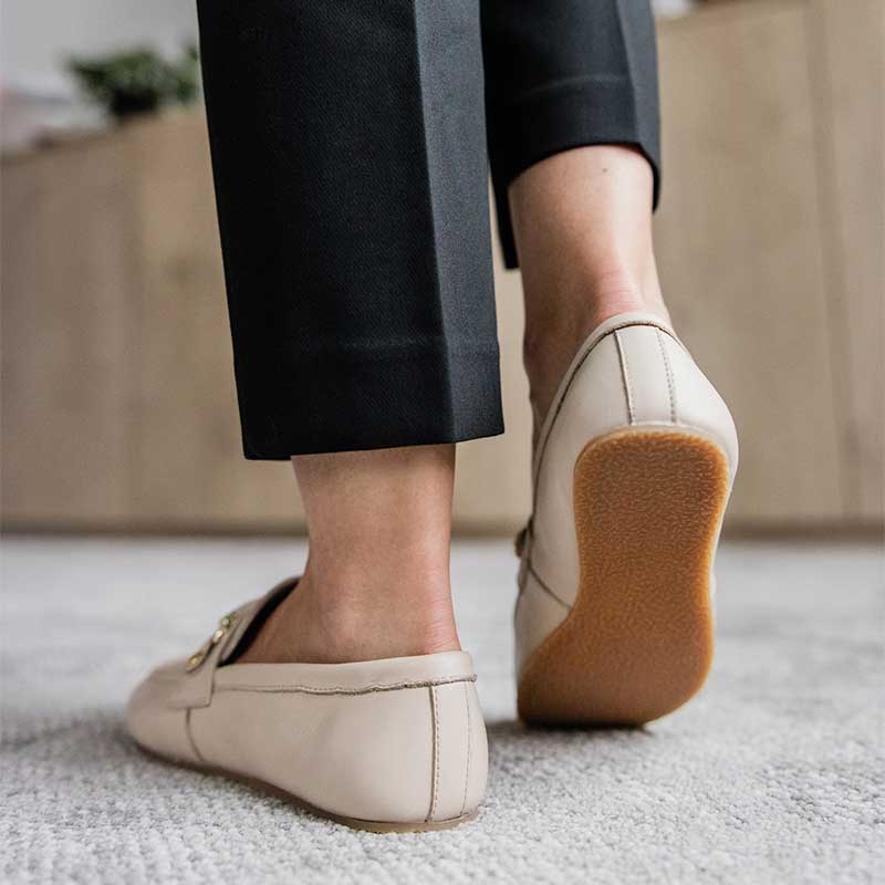 Person wearing Shapen Women's Versa 2.0 Loafers - Beige with black trousers.