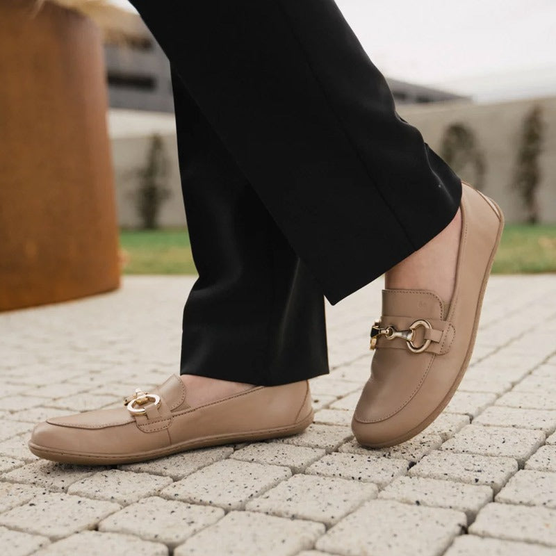 Person wearing Be Lenka Women's Moccasins Viva - Latte Brown with black trousers, inner and outer side view