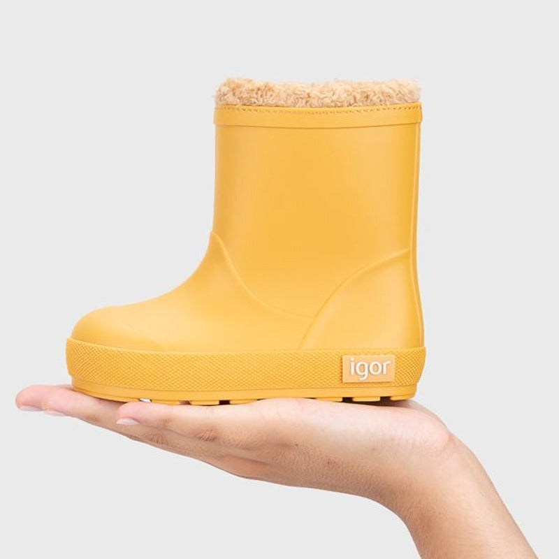 Person holding Igor Yogi Barefoot Warm Wellington Boot - Amarillo Yellow from underneath.