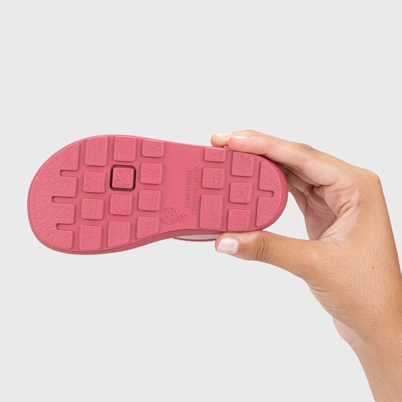 Person holding Igor Yogi Barefoot Warm Wellington Boot - Frambuesa Raspberry, sole view.