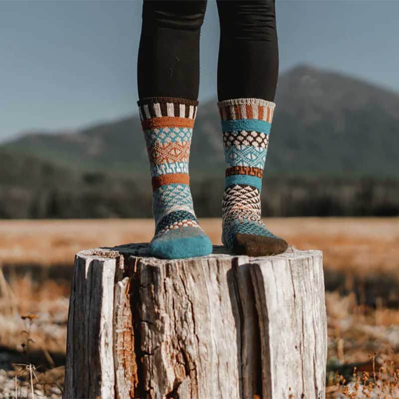 Person wearing Solmate Adults Wool Socks - Walnut with black trousers.