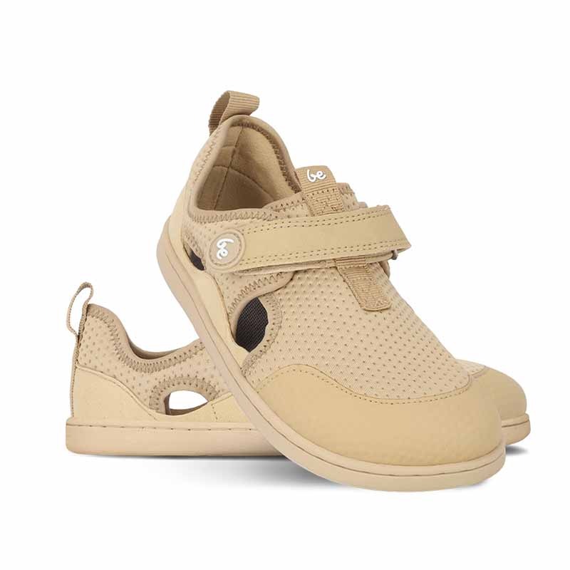 Pair of Be Lenka Kids Sandals Zest - Beige, one angled and leaning showing the outer side, the other partially showing the inner side