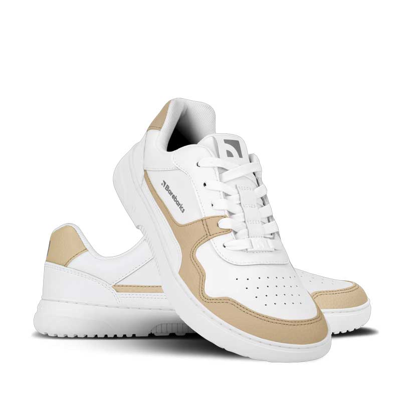 Pair of Be Lenka Adults Barebarics Leather Trainers Zing - White and Cream, one angled and leaning showing the outer side, the other partially showing the inner side